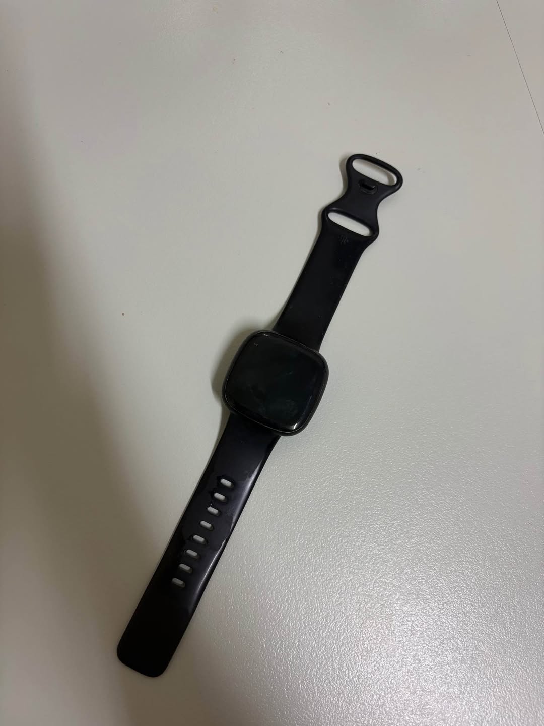 Fitbit Versa 3 smartwatch with charger