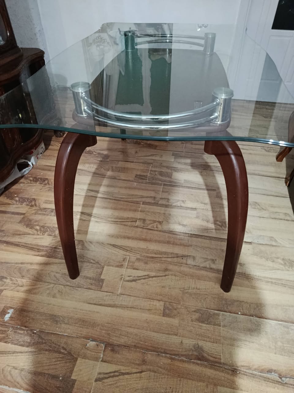 Glass-top table with wooden legs