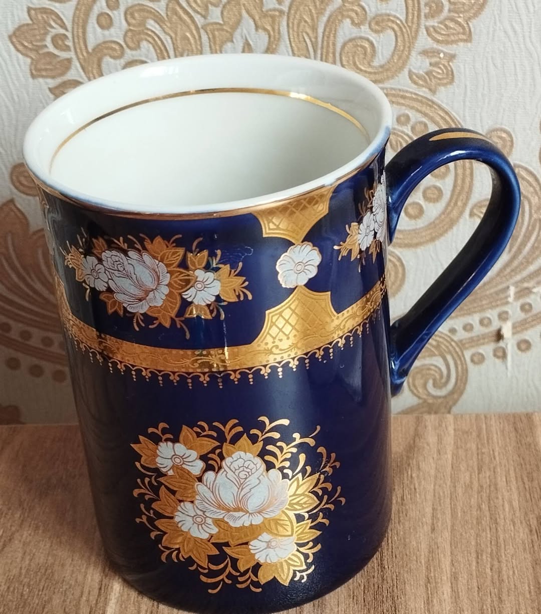 Blue china cup with golden pattern