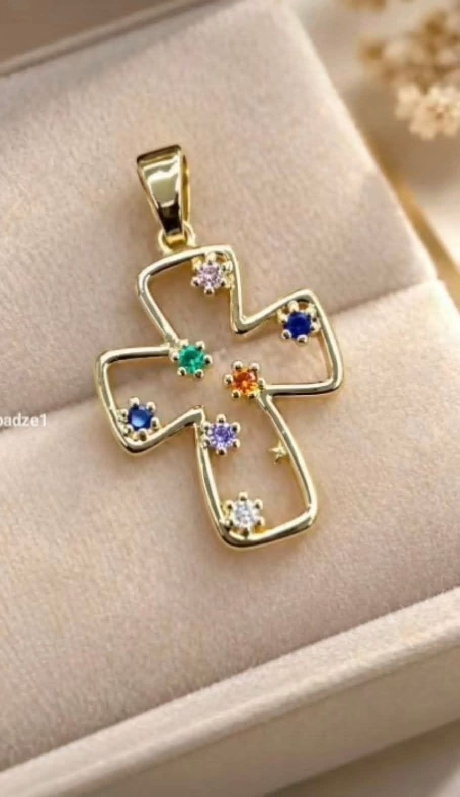 Gold cross pendant with coloured stones