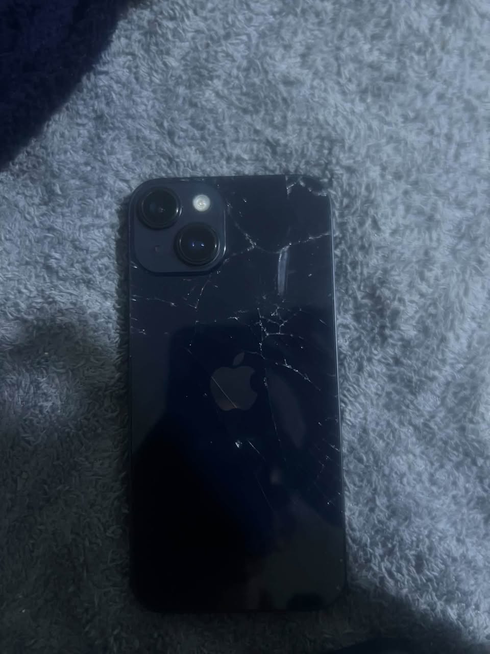 iPhone 13 with cracked back glass