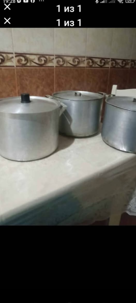 Three large aluminium cooking pots