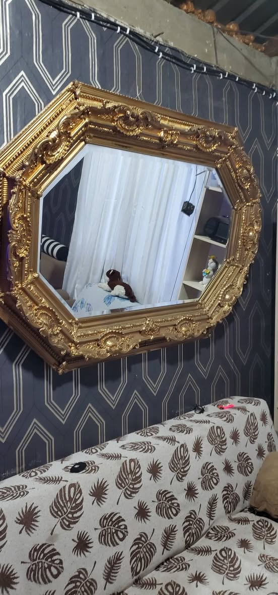 Ornate gold-framed wall mirror