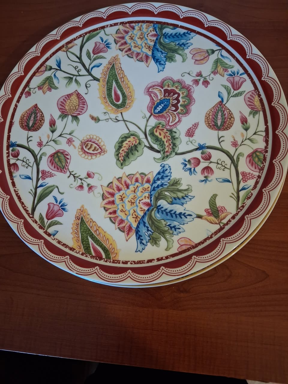Decorative floral plate with a red border