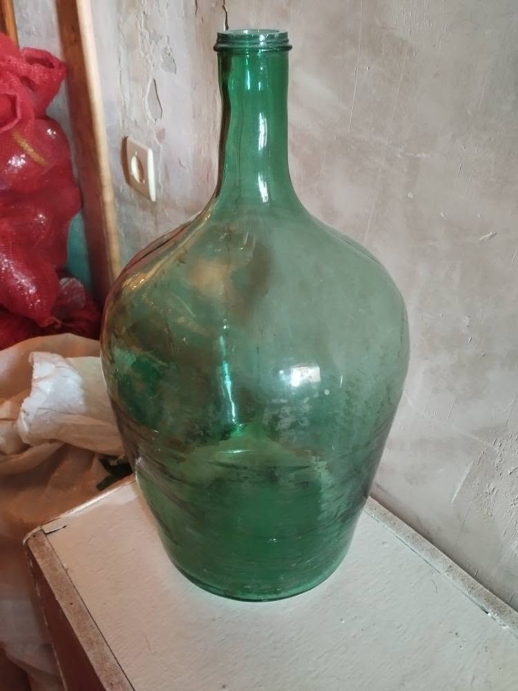 Large green glass demijohn bottle
