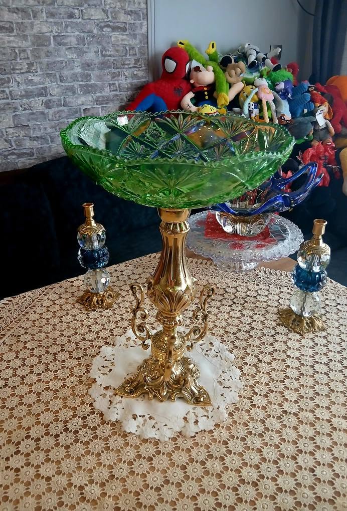 Green cut-crystal bowl on brass stand