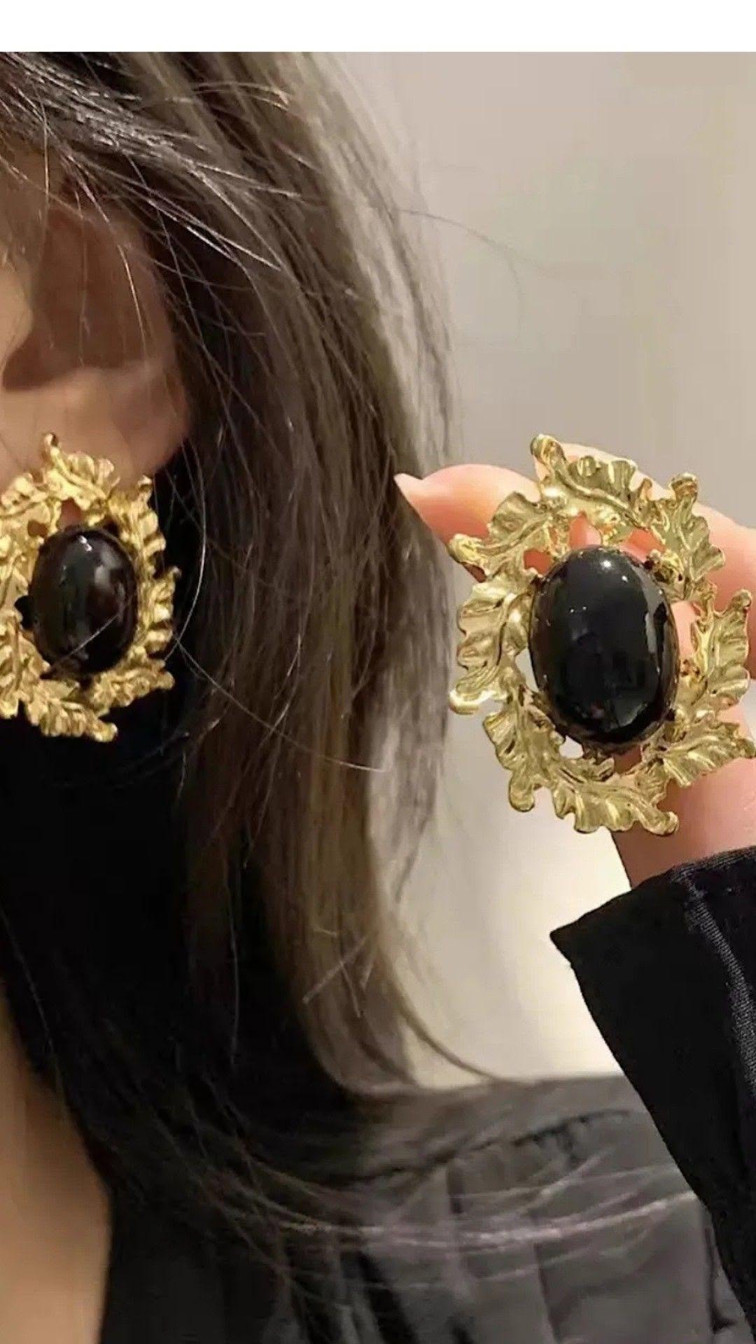 Gold earrings with black stone