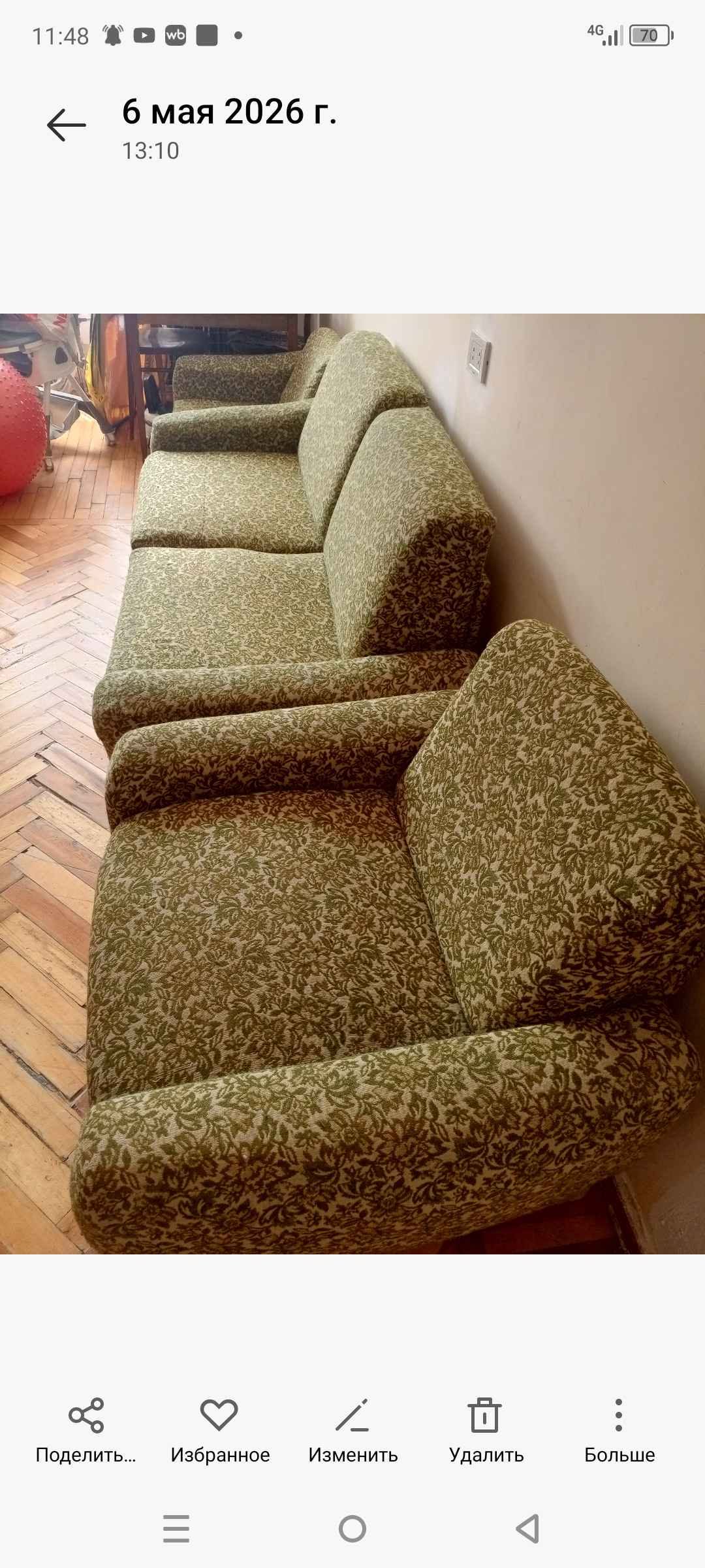 Green flowered sofa is for sale