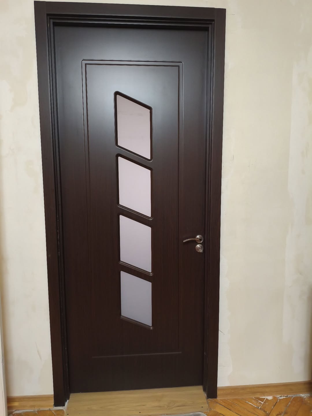 Dark brown doors, unopened in their frames