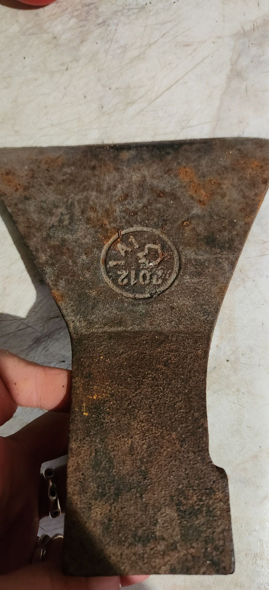 Rusty stamped axe head, 100 GEL
